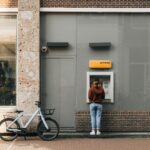 a person standing in front of a atm machine