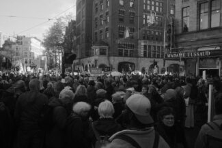 A large crowd of people walking down a street