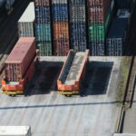 a train yard with cargo containers and train tracks