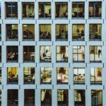 people inside high-rise building with concrete wall