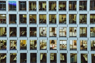 people inside high-rise building with concrete wall