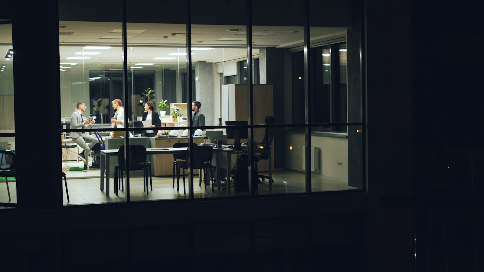 People working late in a modern office at night