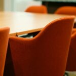 Orange chairs around a wooden conference table