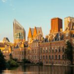 A large building with a lot of windows next to a body of water