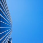 low-angle photography of curtain glass building under blue sky