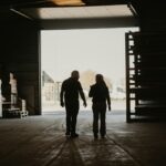 a man and a woman walking into a garage