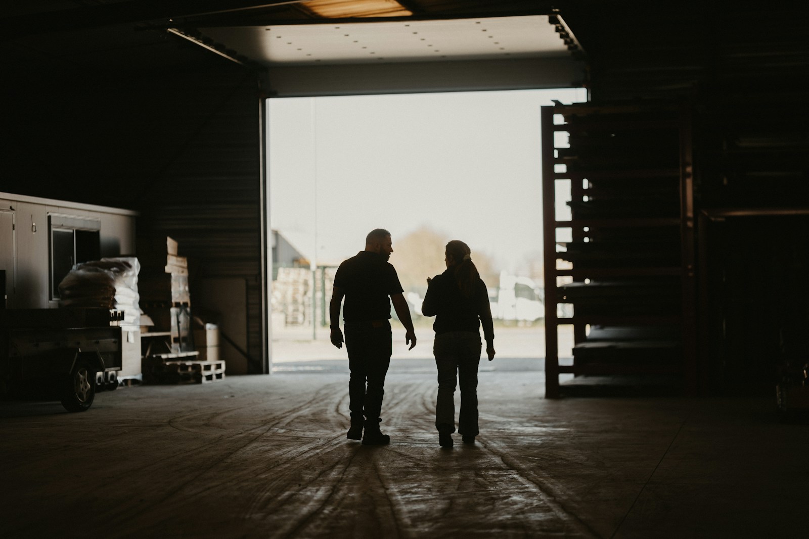 a man and a woman walking into a garage