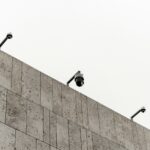 a couple of cameras sitting on top of a wall