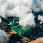 aerial photo of wind turbines near field