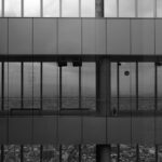 grayscale photography of two men inside building