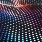 A grid of cubes forming a wave pattern with blue and pink lighting