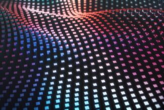A grid of cubes forming a wave pattern with blue and pink lighting