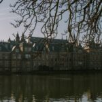 a large building sitting next to a body of water