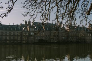 a large building sitting next to a body of water