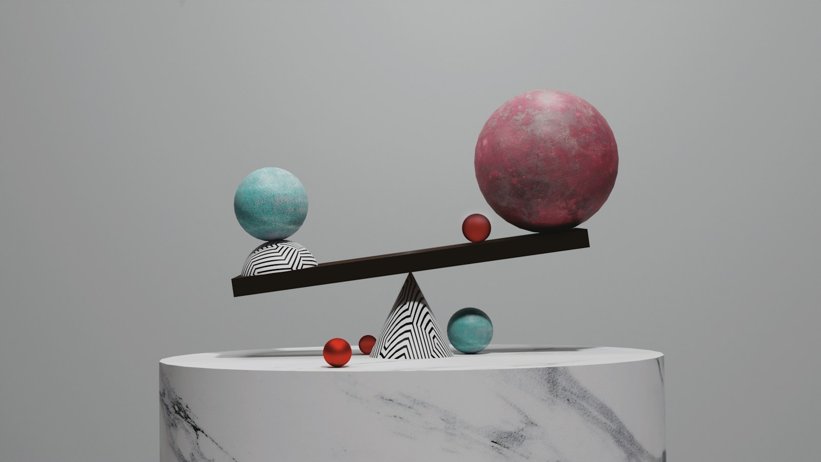 A balance scale with spheres on a marble pedestal against a grey background