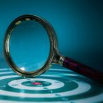Magnifying glass over a target with bullseye